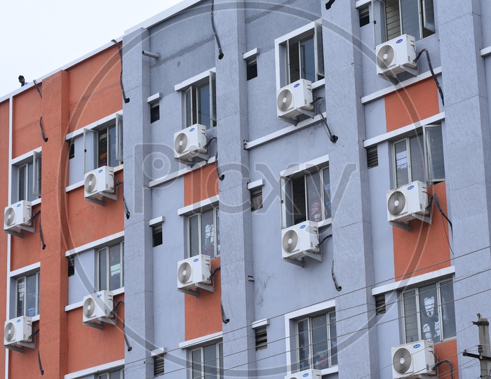 Air Conditioner Compressors Fixed to the Windows in an apartment in Hyderabad