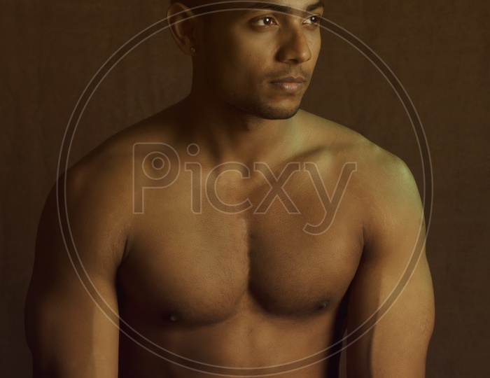 Indian Male Bodybuilder Posing Over an Isolated Background