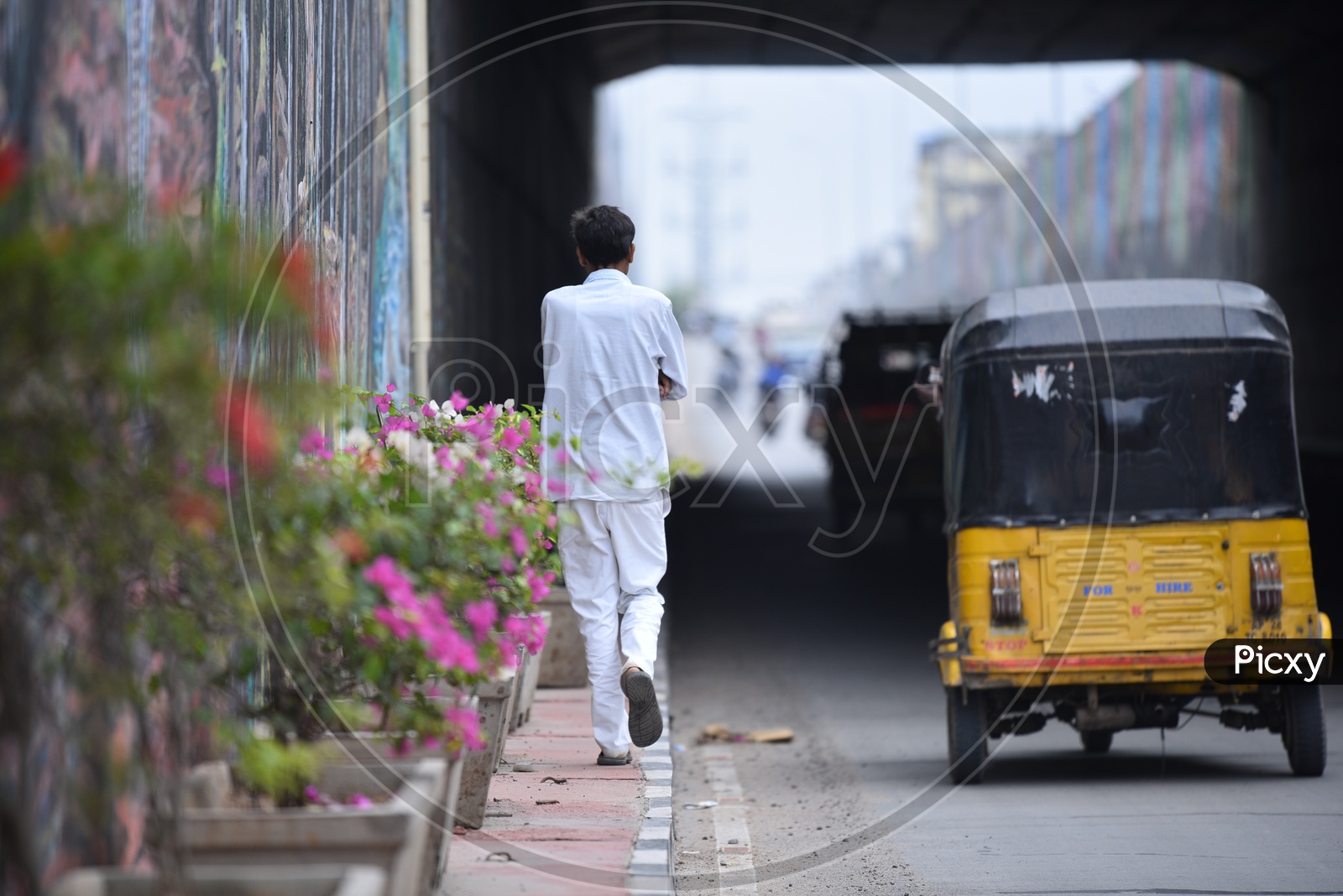 Pedestrian Walking on a Footpath in an Underpass in Hyderabad