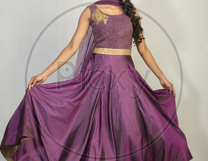 Indian girl dressed up in purple dress  portrait in Studio Lighting / Traditionally dressed up girl