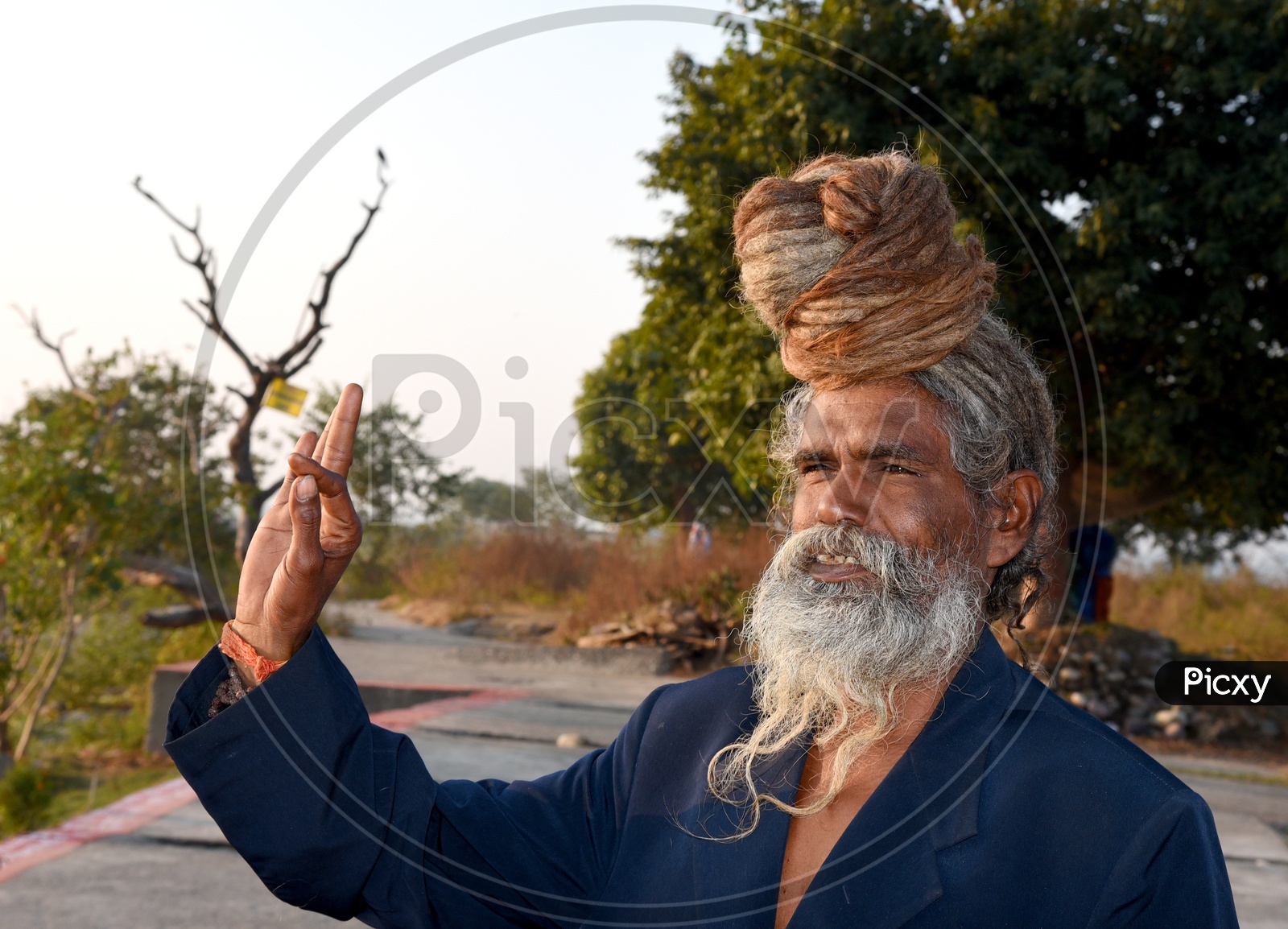 An Indian Old Man With Beard and Long hair Bun Smiling  / Sadhu / Baba