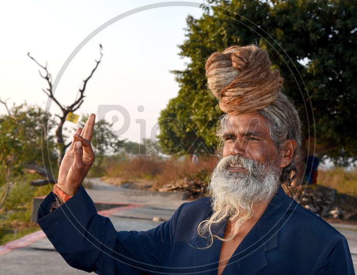 An Indian Old Man With Beard and Long hair Bun Smiling  / Sadhu / Baba