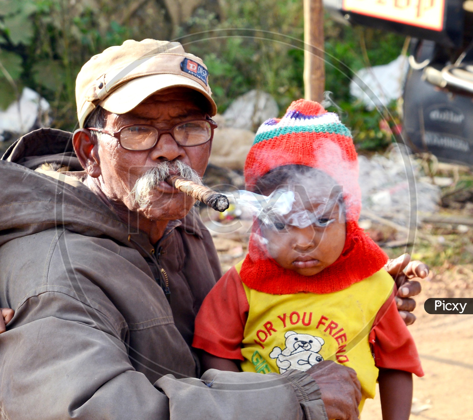Old man Smoking with a Araku Tribal Child in hand