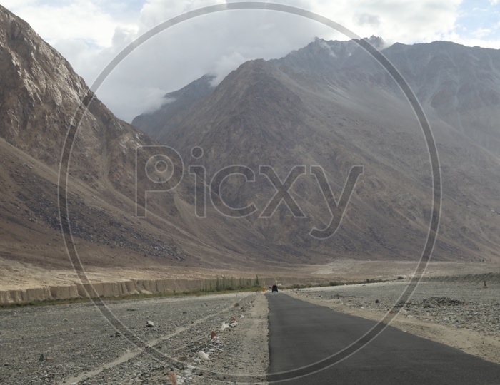 Roads in Leh / Ladakh with Sand Dunes and Mountains In Background