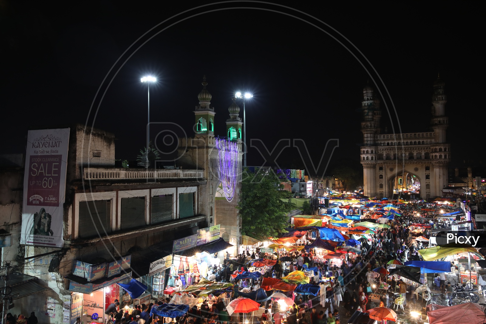 Mecca Masjid near Charminar and Stalls around colorful/Indian Monument