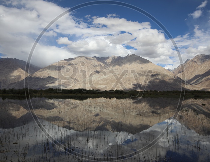 A Beautiful Reflection of Mountains in Water in River valleys of Leh
