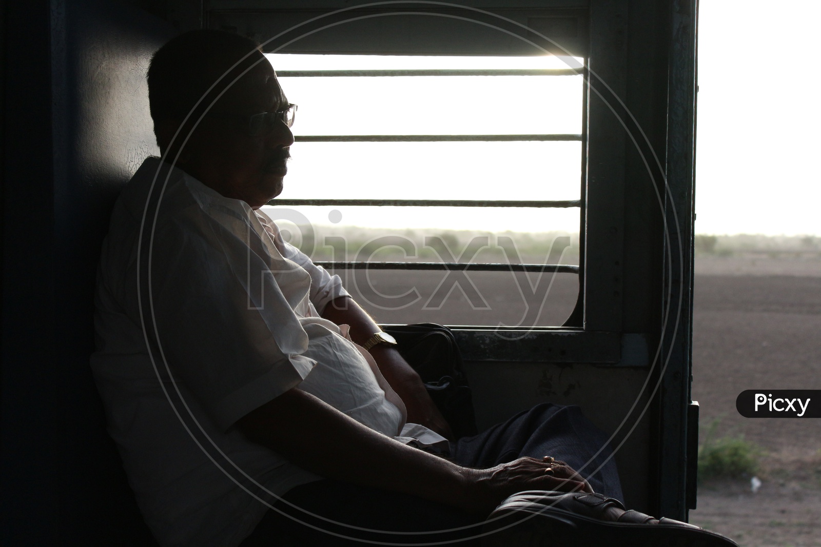 Man enjoying the train ride sitting beside the window - Indian Railways - Coach S3