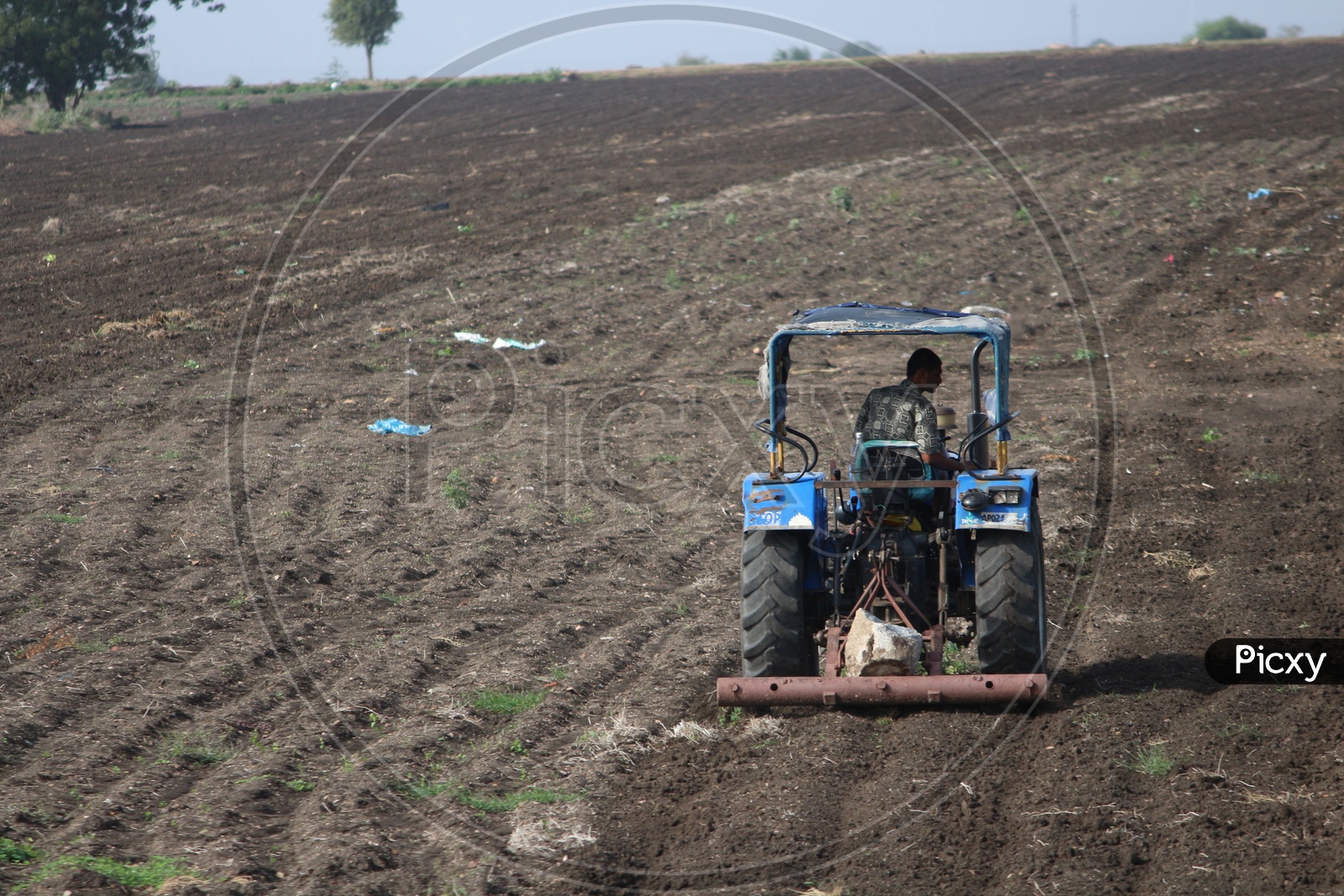 Farmer farming with tractor in Agriculture fields