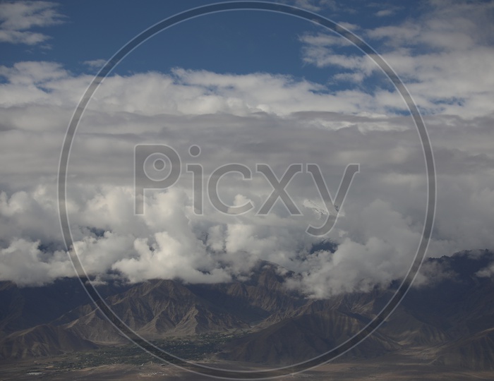 A Beautiful View Of Leh With Mountains And Sky With Clouds as a Background