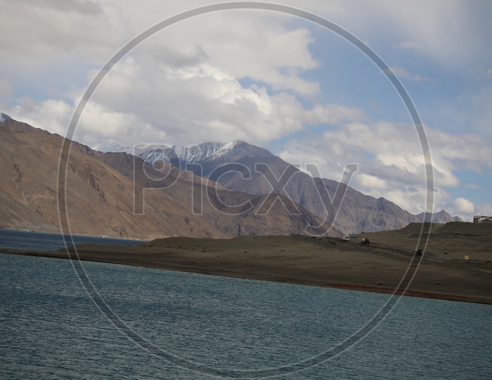 Beautiful River Valleys Of Leh / Ladakh with Sand Dunes , River and Cloudy Sky in Background Composition Shot