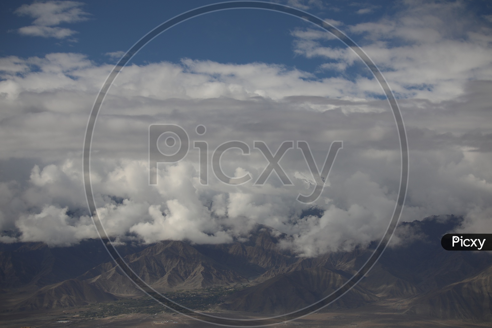 A Beautiful View Of Leh With Mountains And Sky With Clouds as a Background