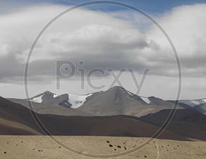 Beautiful Landscape of Snow Capped Mountains from Leh with huge clouds