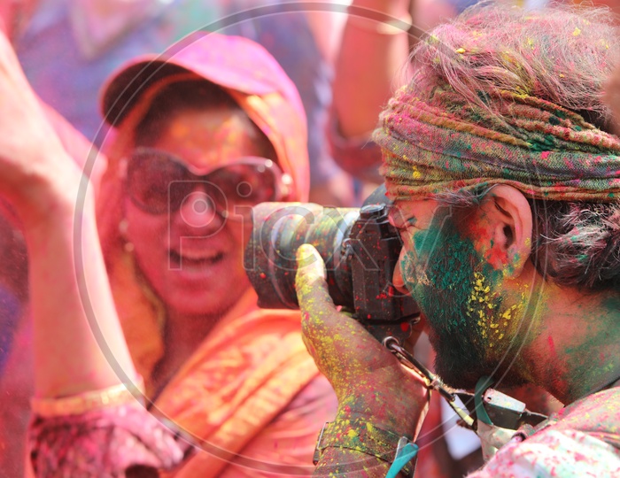 Photographer capturing photos in Holi celebrations in Barsana