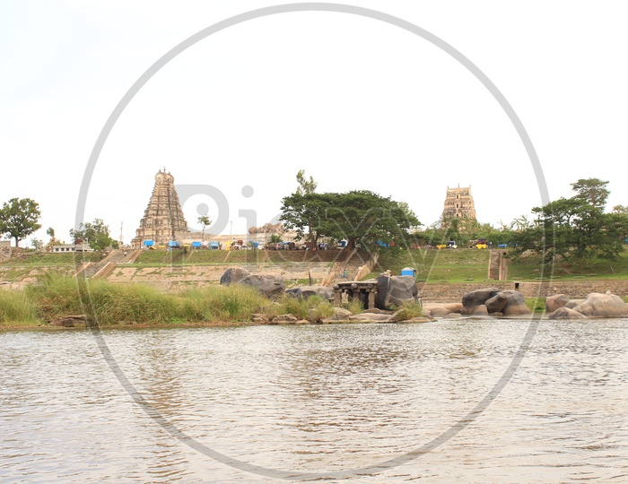 Temple with lake in the foreground in Hampi