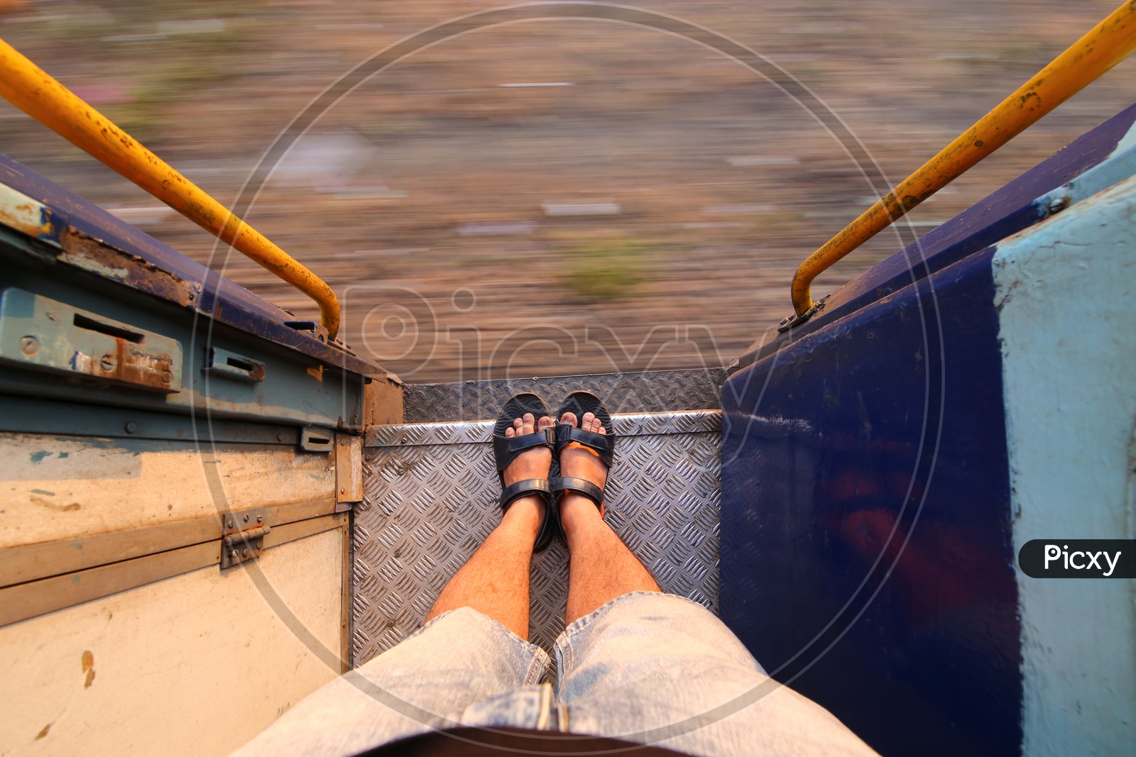 A Composition Shot of Man Foot Standing On Foot board of a Moving Train