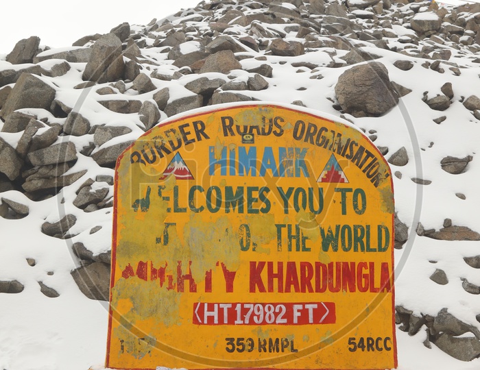 A Mile Stone With Kardhungla Highest Feet On the Snow Filled Mountains