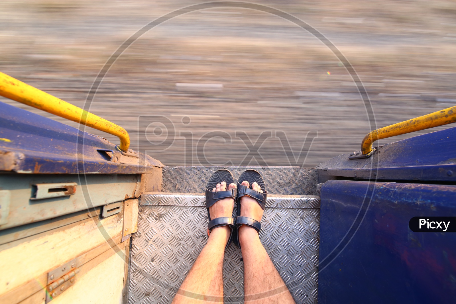 Closeup Shot Of Foot of a Man Standing on a Foot Board Of a  Running Train