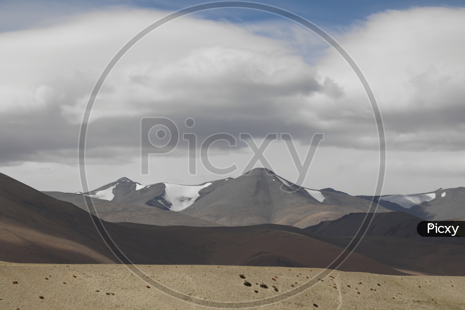 Beautiful Landscape of Snow Capped Mountains from Leh with huge clouds