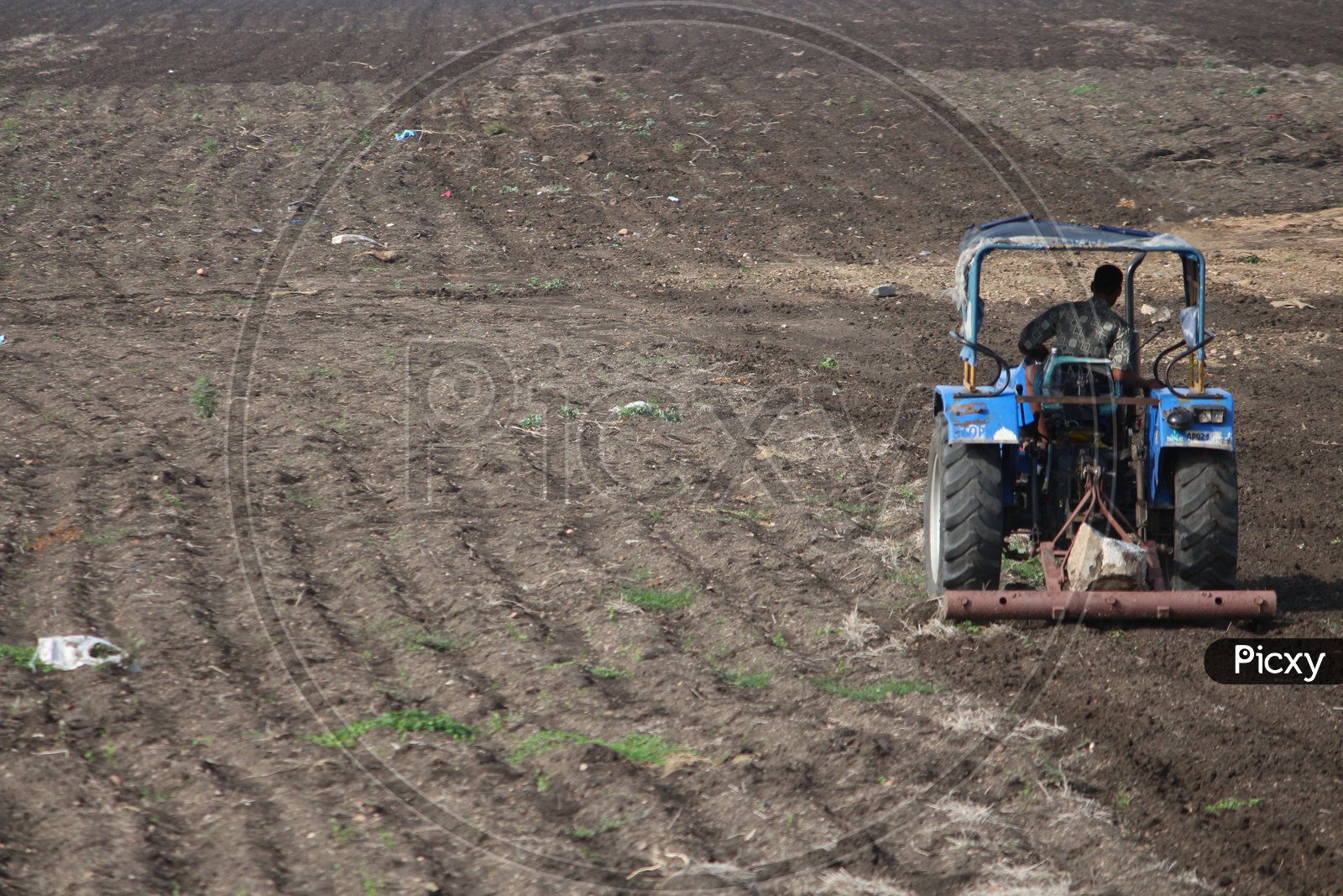 Farmer farming with tractor in Agriculture fields