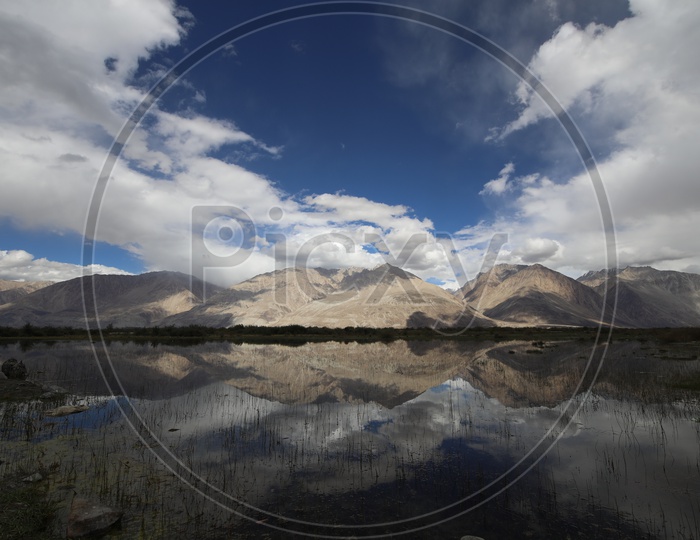 A Beautiful Reflection of Mountains on Water in River valleys of Leh
