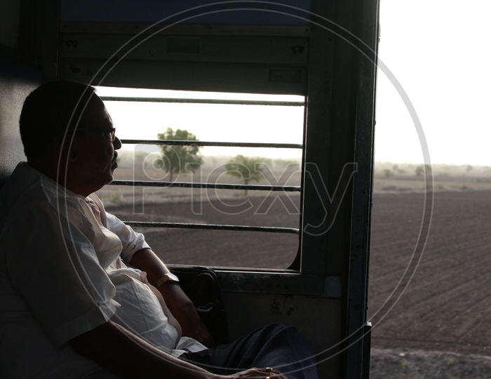 Man enjoying the train ride sitting beside the window - Indian Railways - Coach S3