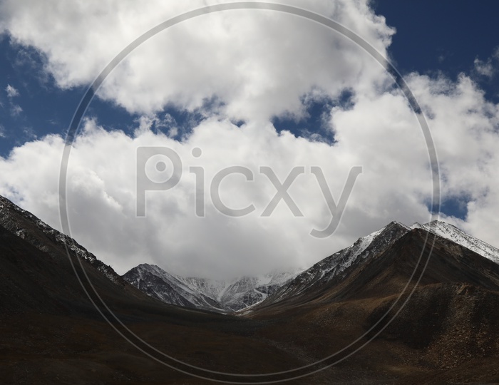 A Beautiful View Of Leh With Mountains , Valley and Blue Sky With Clouds
