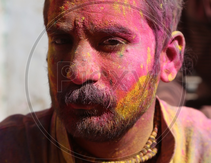 Portrait of Coloured face from Holi  celebrations in streets of Barsana