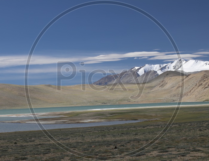 A Beautiful Composition Shot Of River Valley in Leh With Mountains , Sand Dunes and Blue Sky In Background