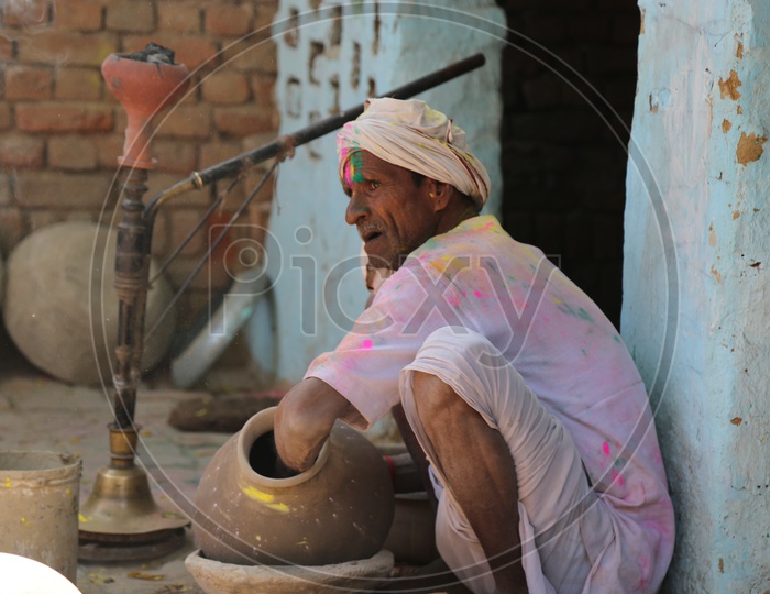 old man making pot in barsana