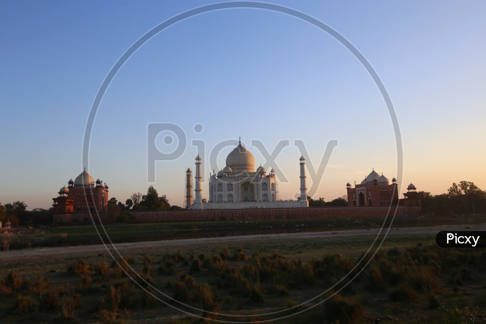 A Beautiful View Of Taj Mahal Over a Sunset and Blue Hour Sky In Background