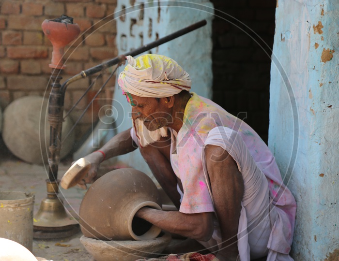 old man making pot in barsana