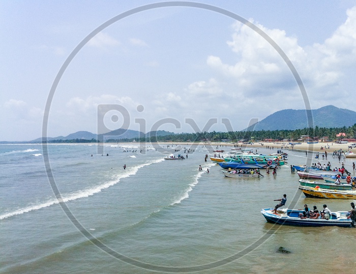 A Beautiful Beach With Fishing Boats and Visitors in Murudeshwar