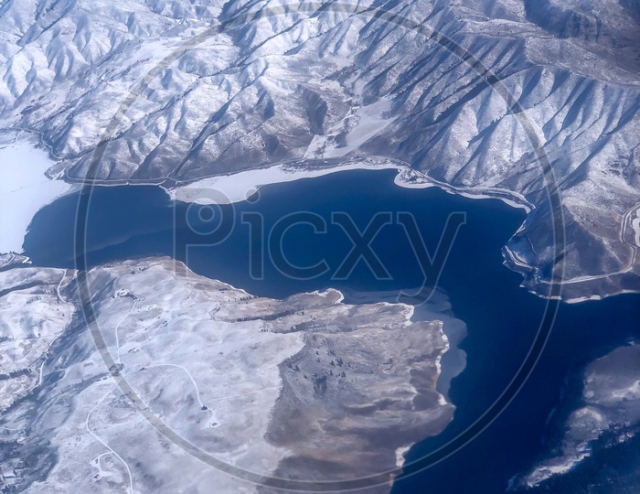 Ariel View of Blue Waters & Snow Capped Mountains