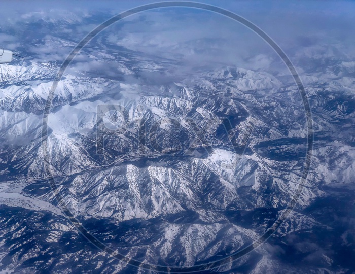 Ariel View of Snow Capped Mountains, Clouds