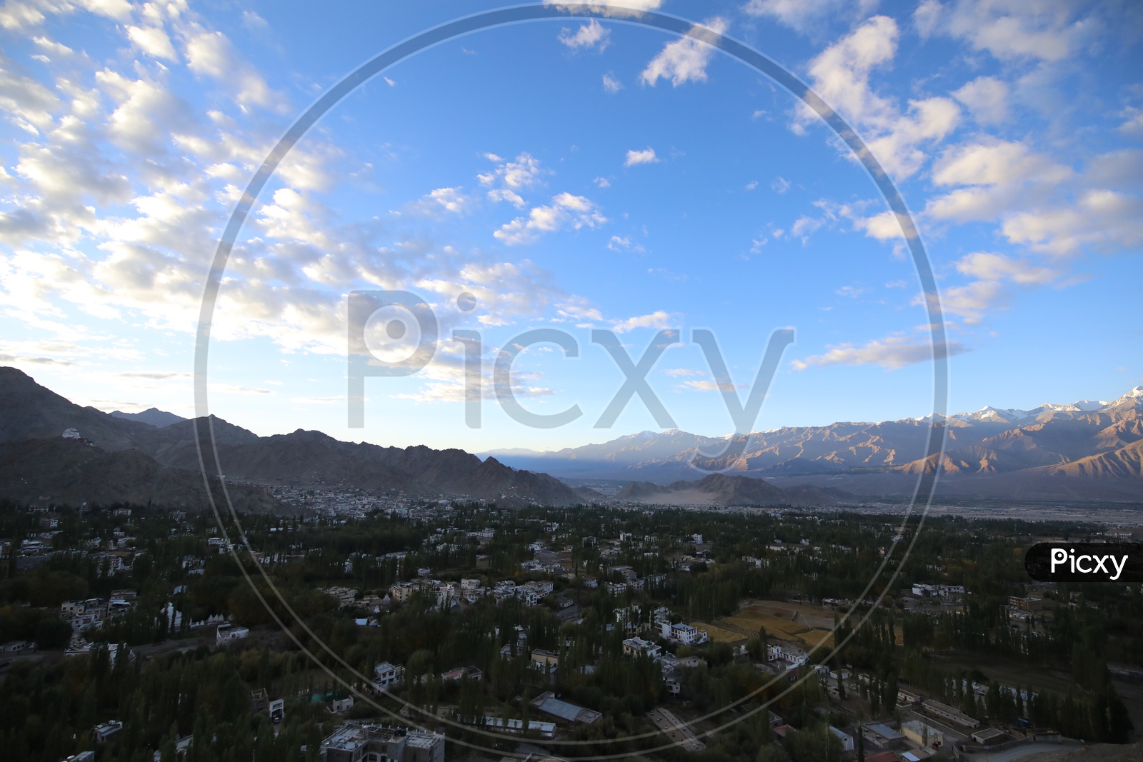 Beautiful Landscape of Snow Capped Mountains of Leh with Village in the foreground