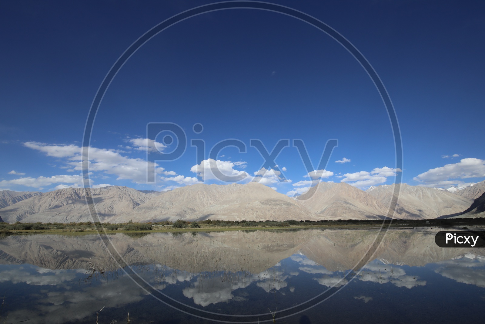 Beautiful Landscape of Snow Capped Mountains of Leh with water reflection