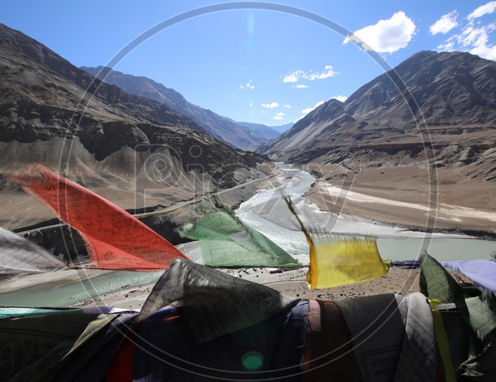 colourful lags with snow capped mountains of leh in background