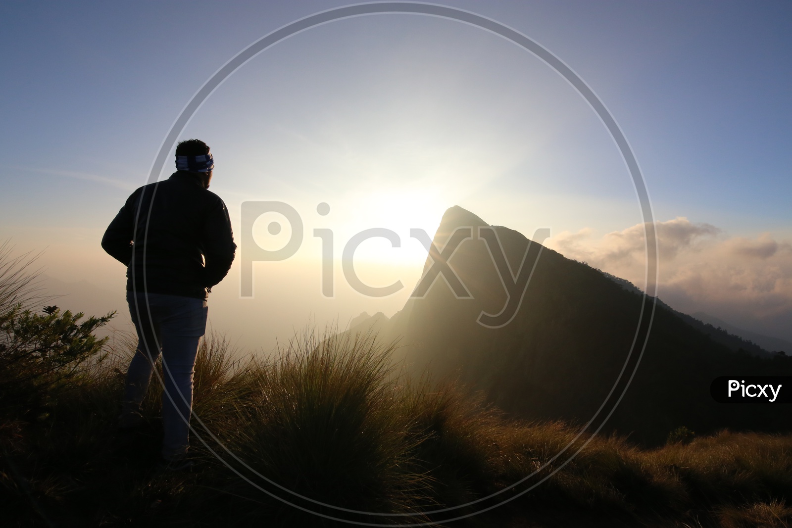 A Silhouette Of a Tourist Over a Beautiful Sunset on Hill Tops Of Munnar