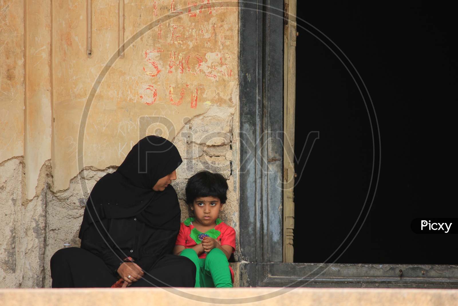 A Beautiful Composition Shot Of a Muslim Mother and Child At Which Mother Looking Her Child intensely