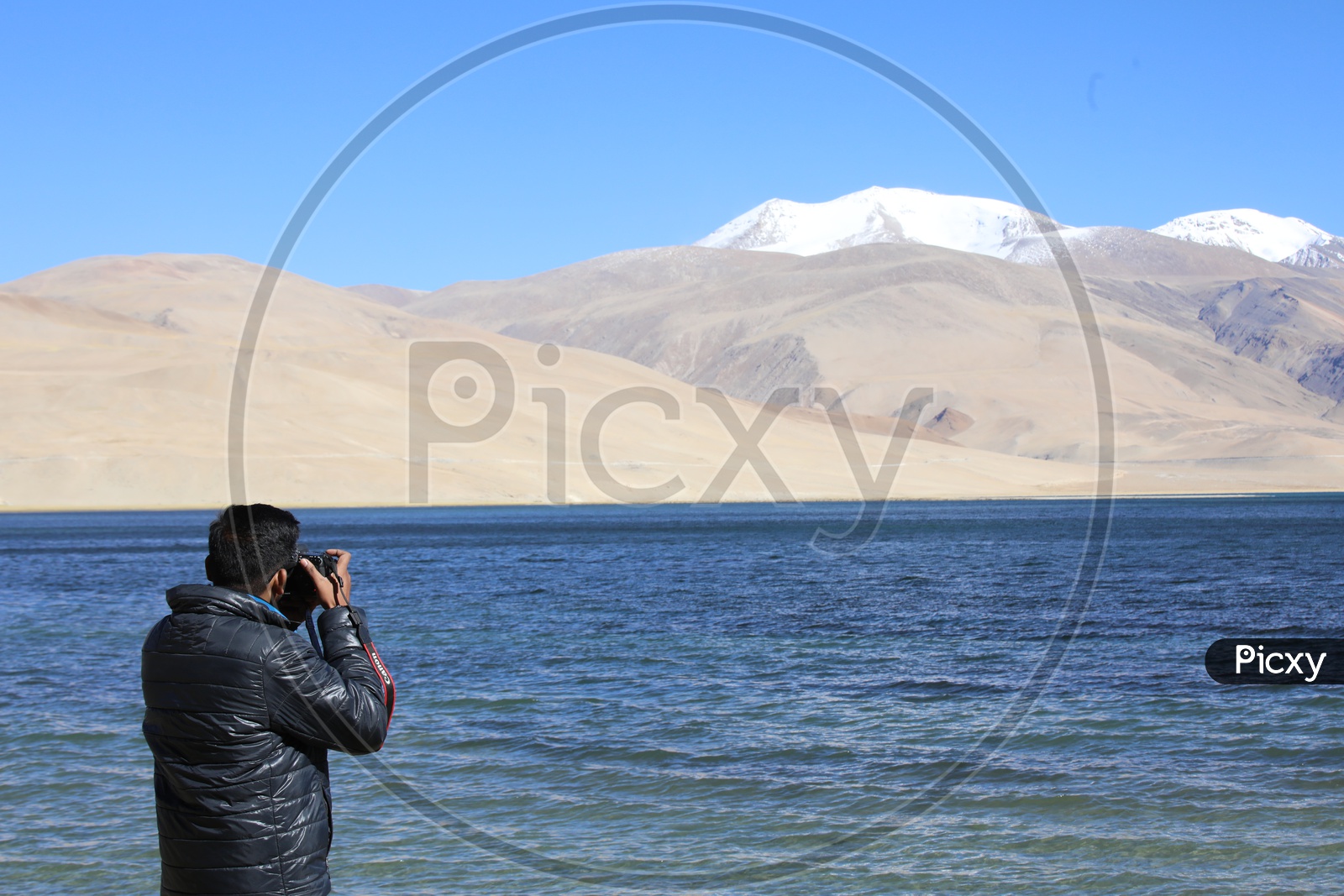 Photographer capturing Mountains of Leh with TsoMoriri Lake