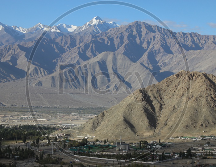 Beautiful Landscape of Snow Capped Mountains of Leh with leh village in the foreground