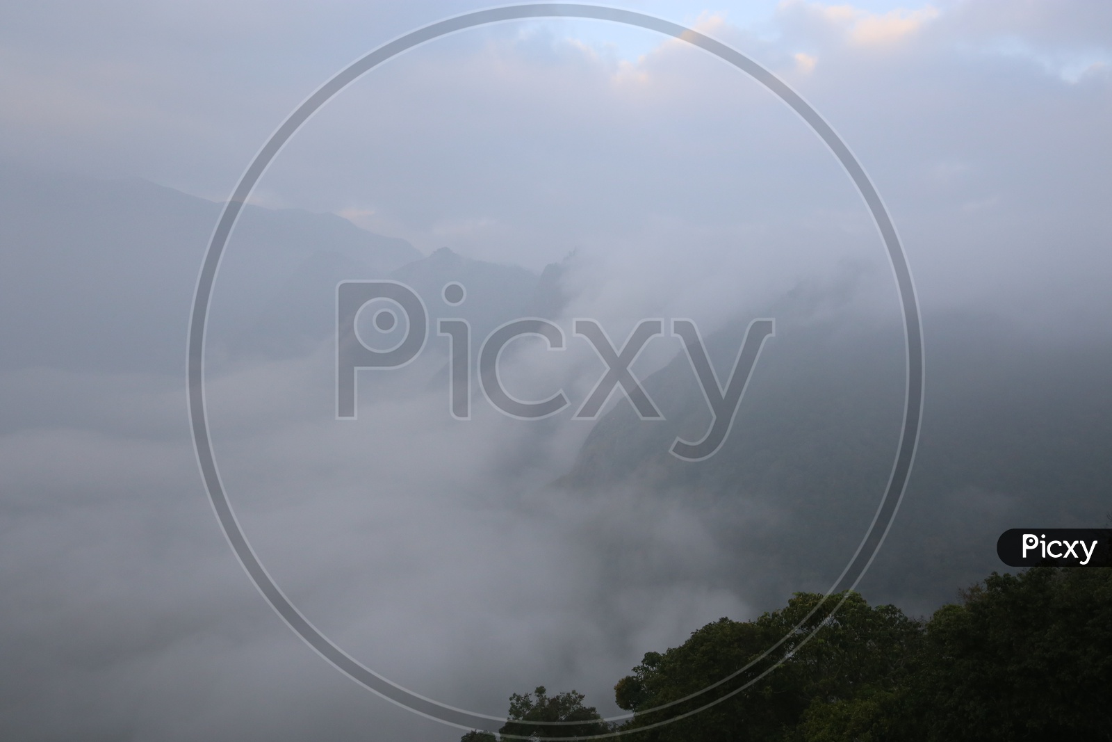 A Beautiful View Of a Landscape With Misty Fog Over The Hills in Munnar