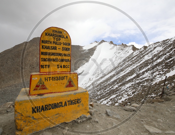 A Sign Stone Of Khardangla Post With  Snow Capped Mountains In The Background