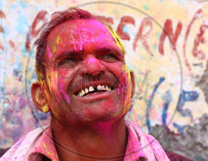 Man with Colors on face - Holi Celebrations - Indian Festival - Colors/Colorful at Nandagaon