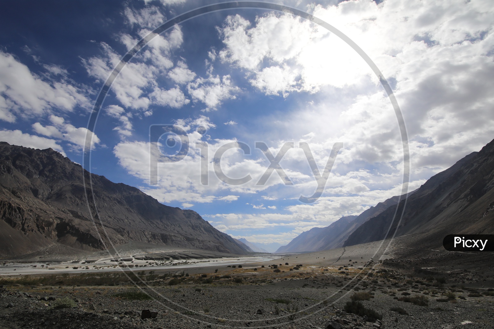 Beautiful Landscape of Snow Capped Mountains of Leh with  water flow in the foreground