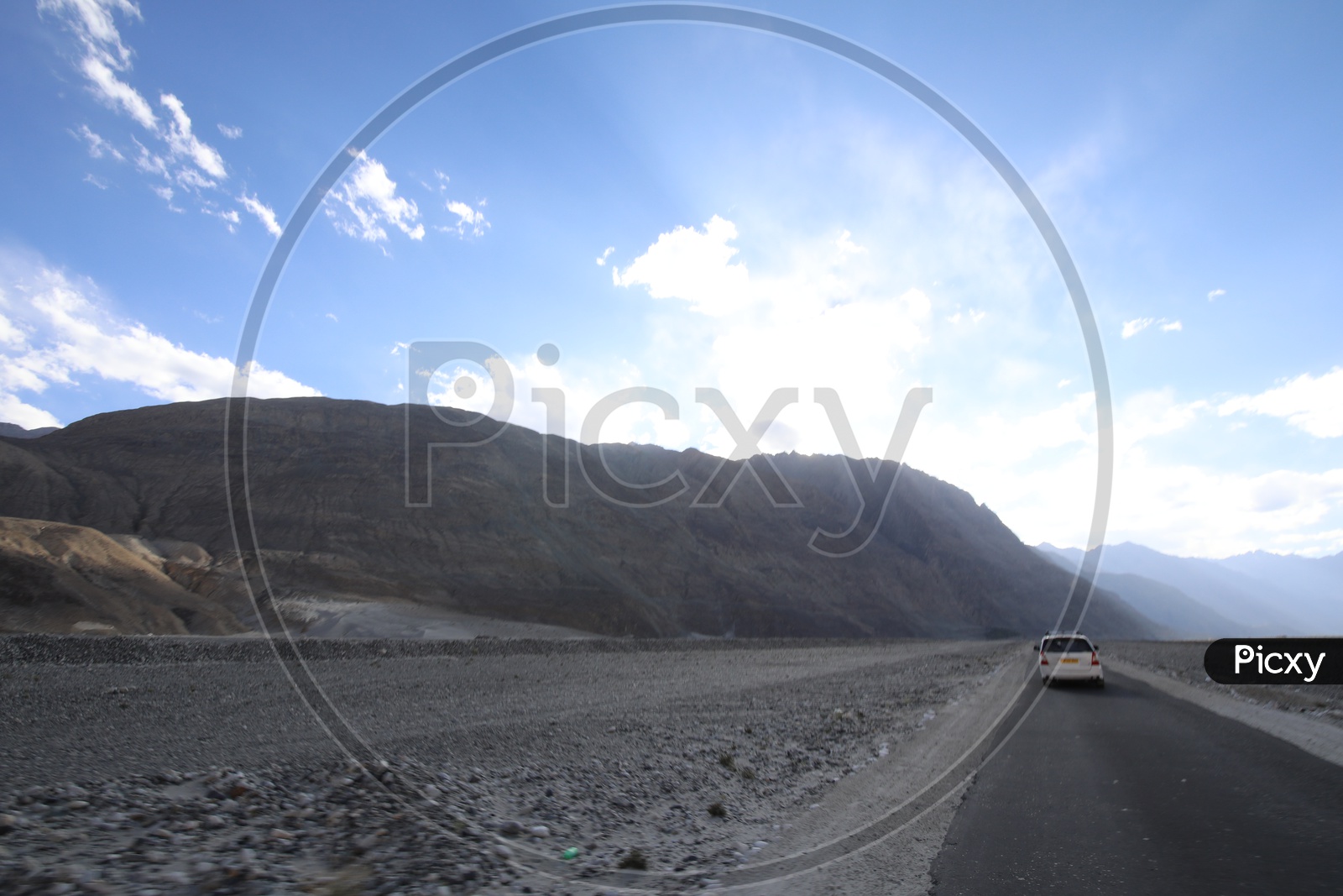 Beautiful Landscape of Snow Capped Mountains of Leh with clouds in sky