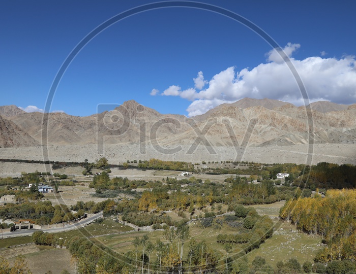 Beautiful Landscape of Snow Capped Mountains of Leh with roadways of leh in foreground