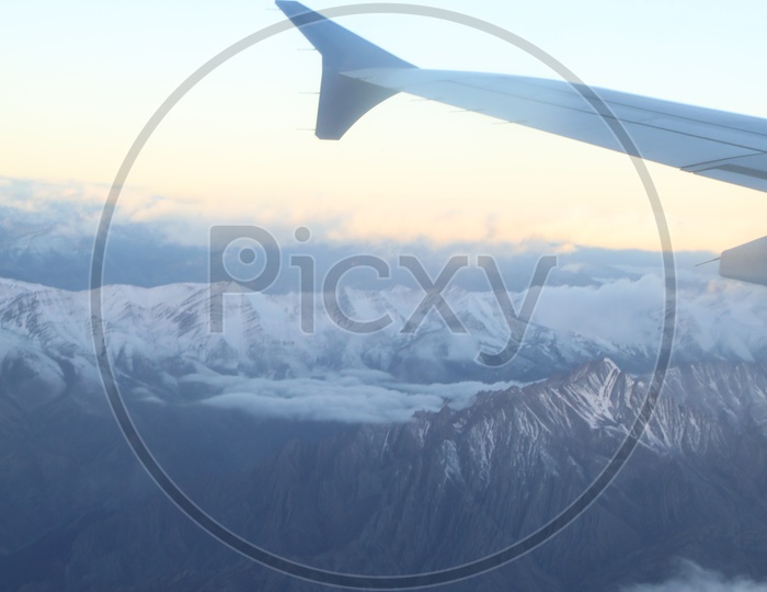 Beautiful Snow Capped Mountains of Leh from flight window / Leh mountains in aerial view