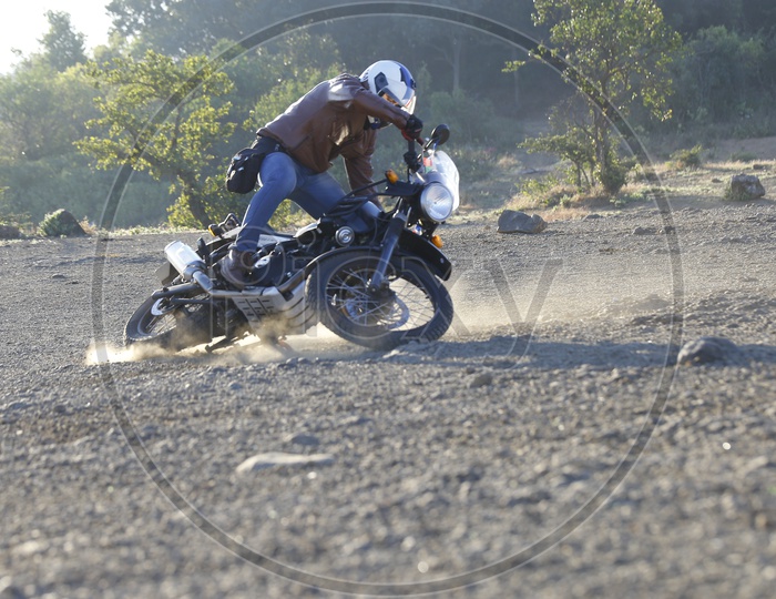 A Bike Rider Doing Stunts With Royal Enfield Himalayan Bike