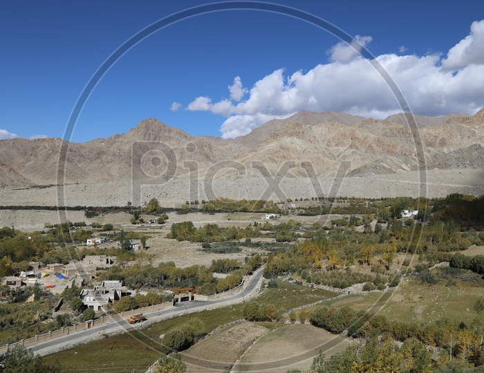Beautiful Landscape of Snow Capped Mountains of Leh with roadways of leh in foreground